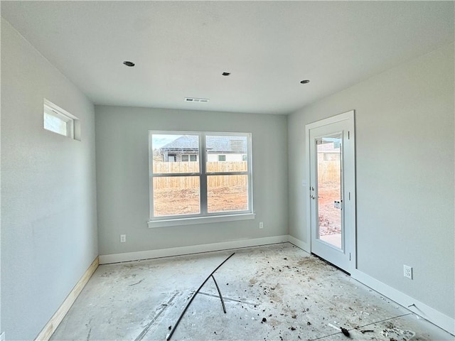 spare room with baseboards and visible vents