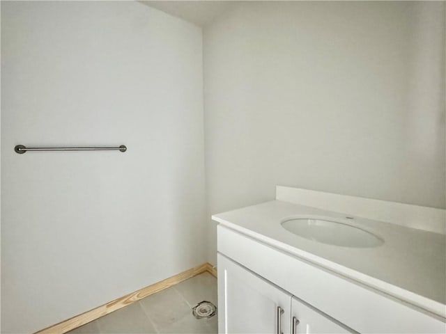 bathroom with vanity, baseboards, and tile patterned floors