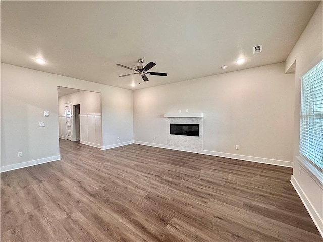 unfurnished living room featuring dark wood-style floors, visible vents, ceiling fan, and baseboards