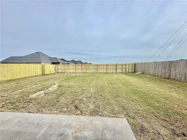 view of yard with a fenced backyard