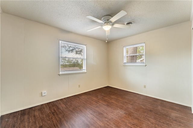 spare room featuring ceiling fan, dark hardwood / wood-style flooring, ornamental molding, and a textured ceiling