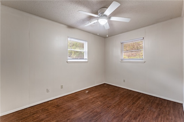 empty room featuring ornamental molding, a textured ceiling, ceiling fan, and dark wood-type flooring