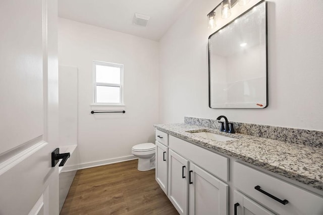 full bath with toilet, wood finished floors, vanity, visible vents, and baseboards