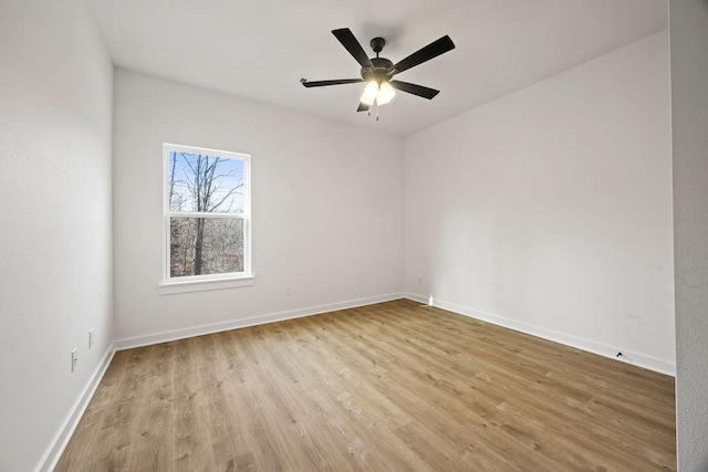 empty room featuring ceiling fan, wood finished floors, and baseboards