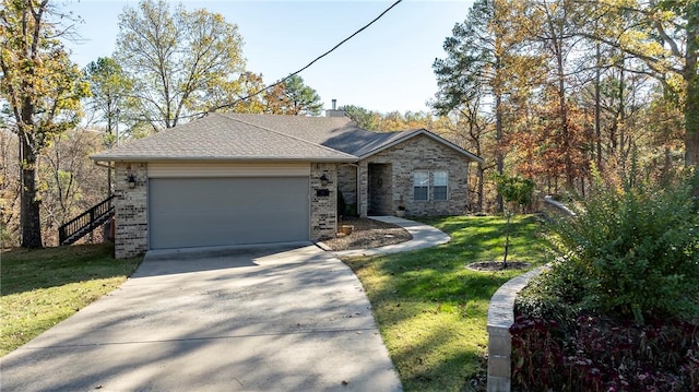 ranch-style house featuring a front yard and a garage