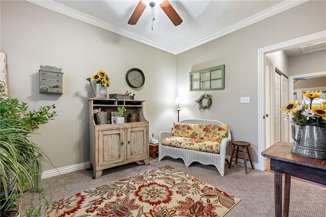 sitting room featuring carpet flooring and crown molding