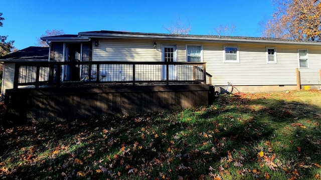 rear view of house featuring a wooden deck