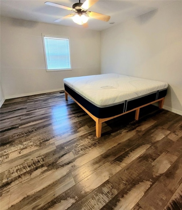 bedroom featuring ceiling fan and dark wood-type flooring