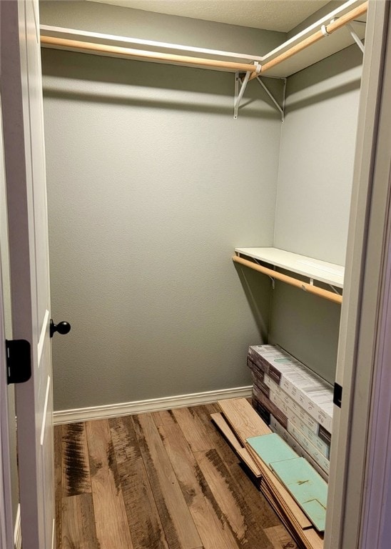 walk in closet featuring hardwood / wood-style flooring