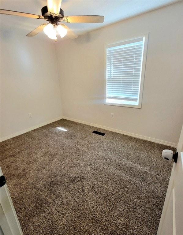 spare room with carpet floors and ceiling fan