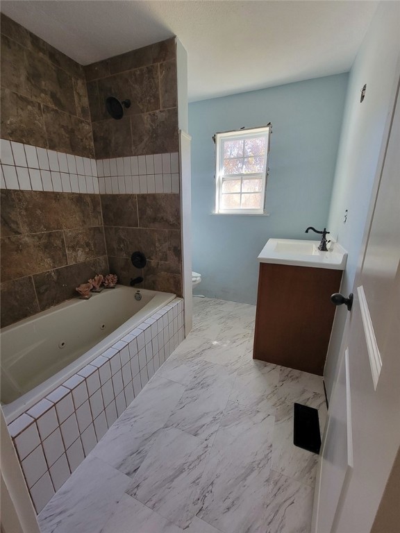 bathroom featuring vanity and toilet