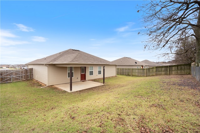 rear view of property featuring a patio area and a lawn