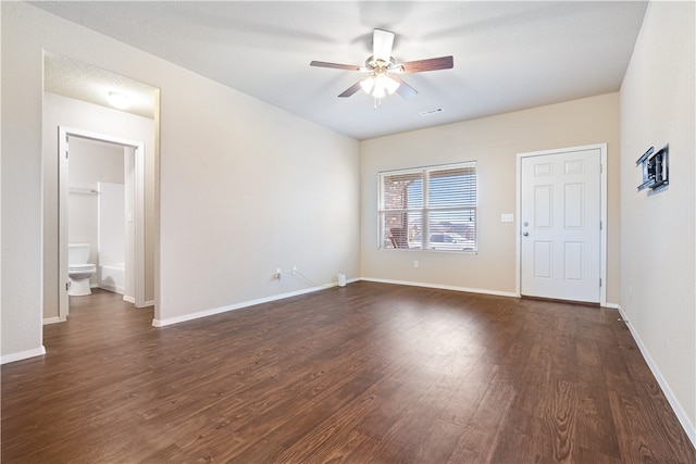 spare room featuring dark hardwood / wood-style flooring and ceiling fan