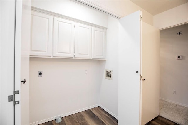 laundry area with electric dryer hookup, cabinets, and dark wood-type flooring