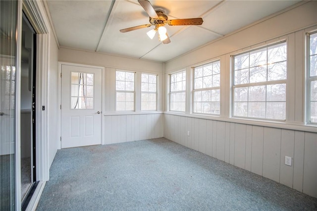 unfurnished sunroom with ceiling fan