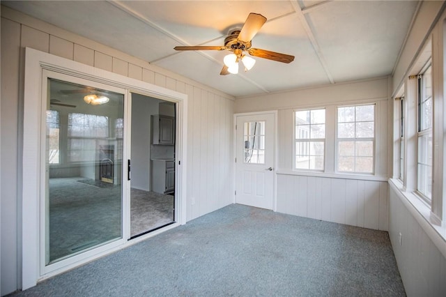 unfurnished sunroom with ceiling fan