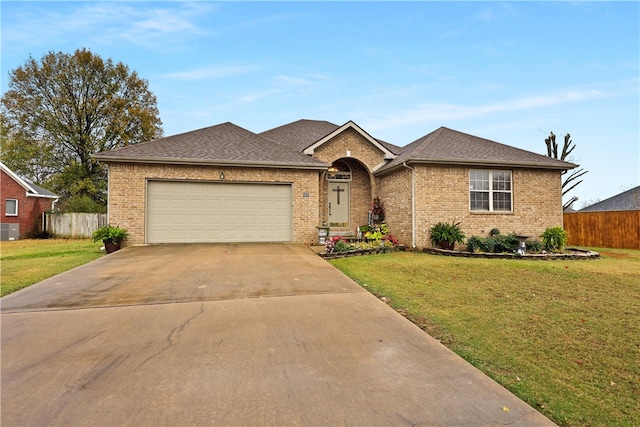 ranch-style house featuring central air condition unit, a front lawn, and a garage