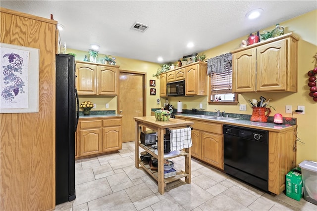 kitchen with black appliances, sink, and a textured ceiling