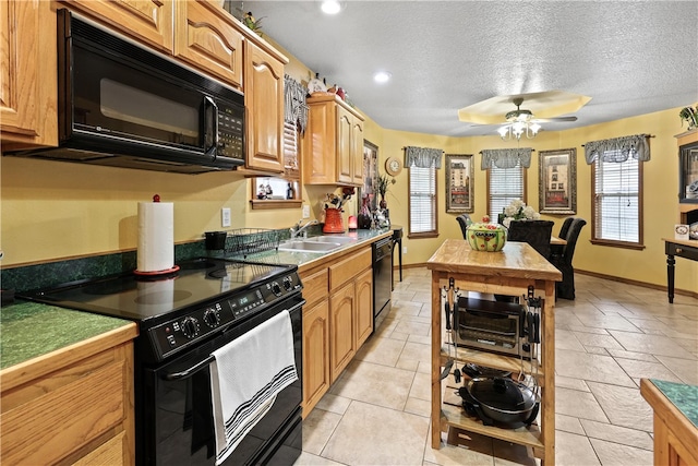 kitchen featuring black appliances, sink, ceiling fan, light tile patterned floors, and a textured ceiling