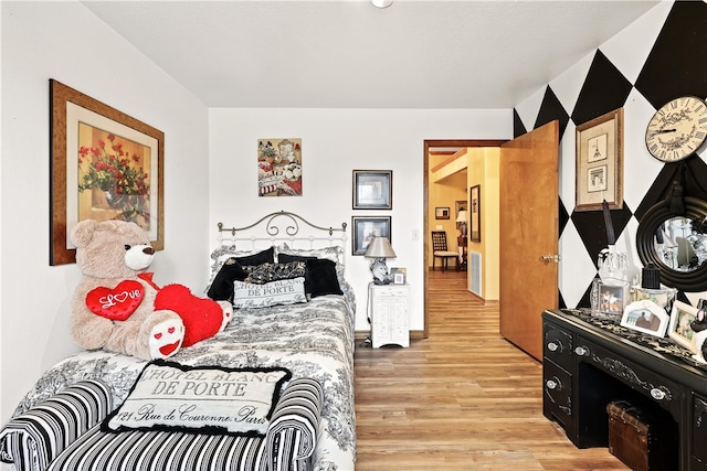 bedroom with light hardwood / wood-style flooring