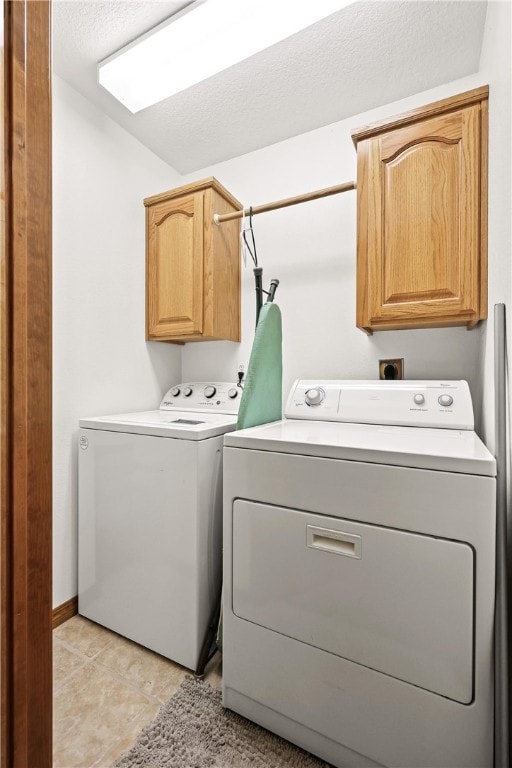 laundry room with cabinets and washing machine and clothes dryer