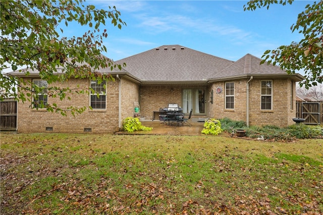 rear view of house featuring a patio area and a yard