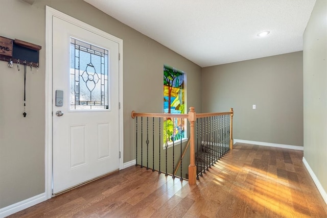 foyer with hardwood / wood-style floors and a textured ceiling