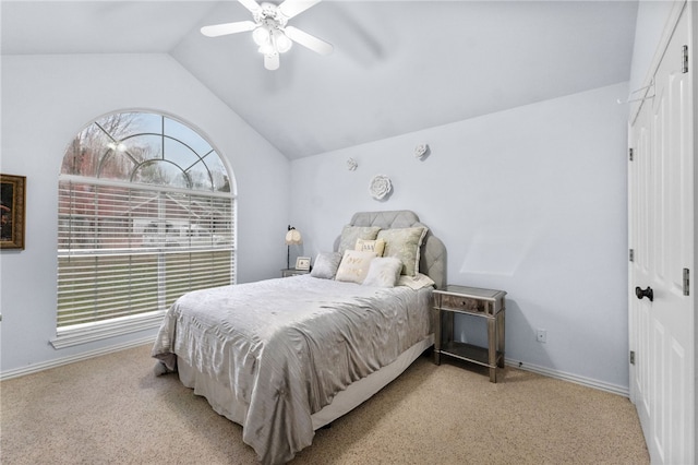 carpeted bedroom with ceiling fan and lofted ceiling