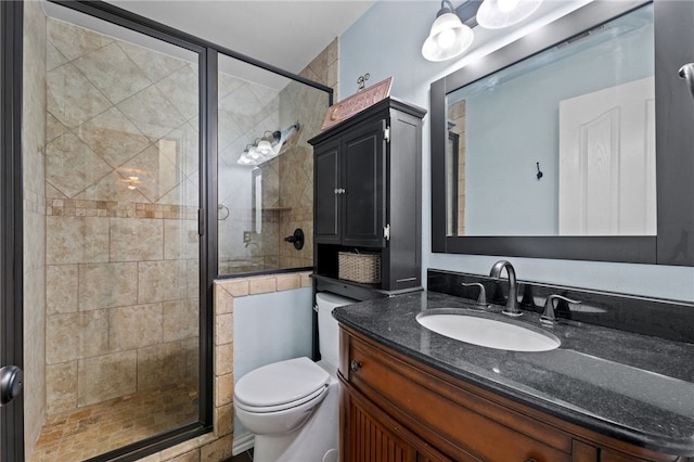 bathroom with toilet, vanity, and walk in shower