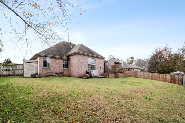 rear view of house featuring a yard