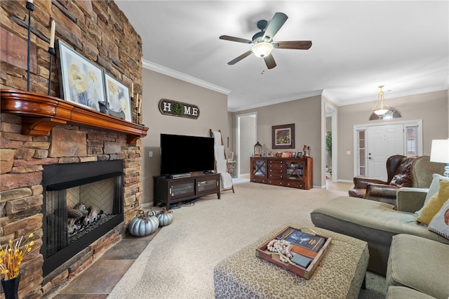 carpeted living room featuring a fireplace, ceiling fan, and crown molding