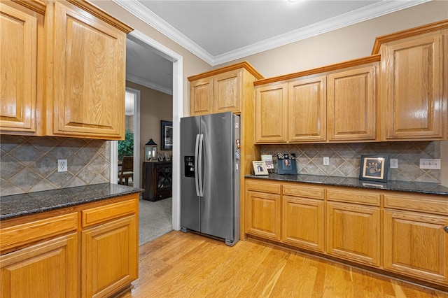 kitchen featuring tasteful backsplash, stainless steel fridge with ice dispenser, ornamental molding, and light wood-type flooring