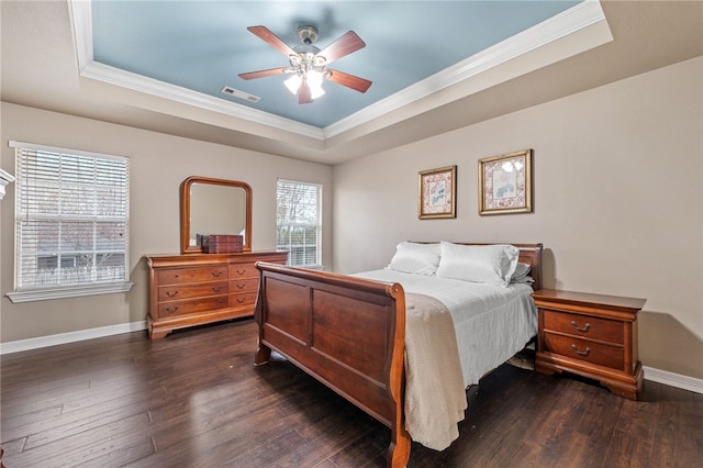 bedroom with a tray ceiling, multiple windows, and ceiling fan