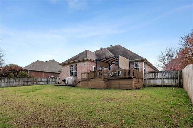 back of property featuring a yard, a pergola, and a wooden deck