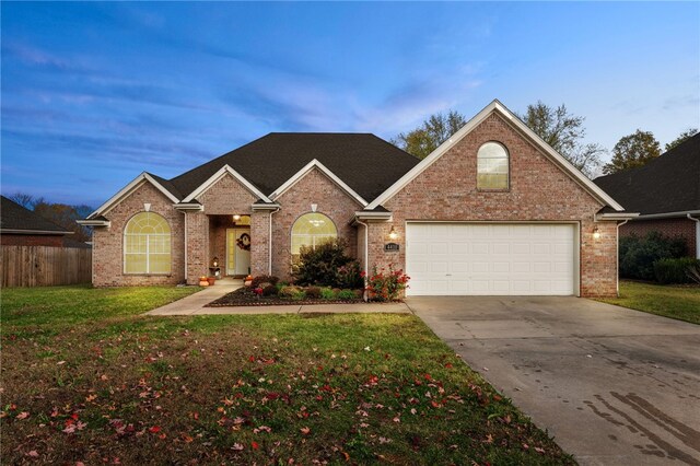 view of property with a yard and a garage