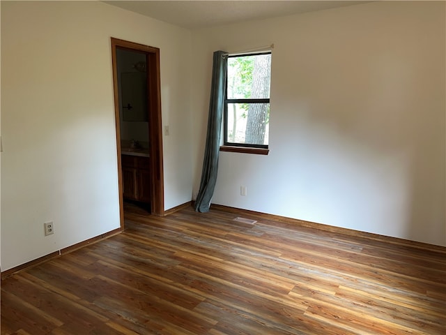 spare room with dark hardwood / wood-style flooring