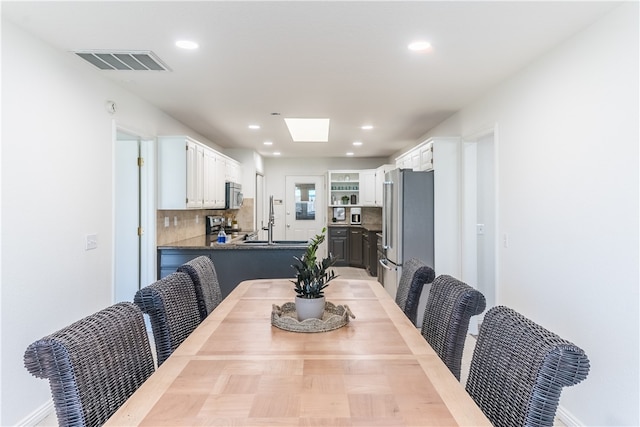 dining space with a skylight