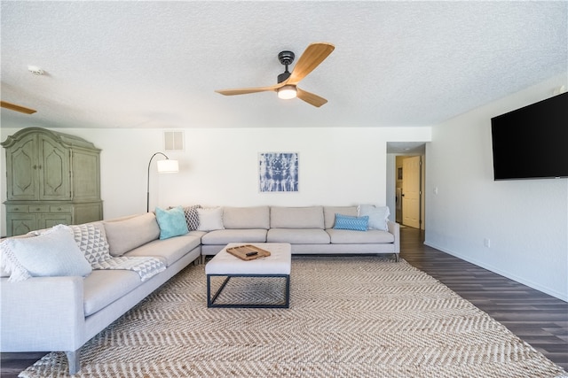 living room with wood-type flooring, a textured ceiling, and ceiling fan