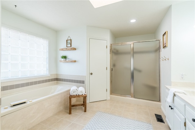 bathroom with tile patterned floors, plus walk in shower, and vanity