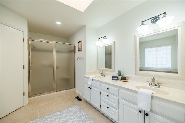 bathroom featuring tile patterned flooring, vanity, and an enclosed shower