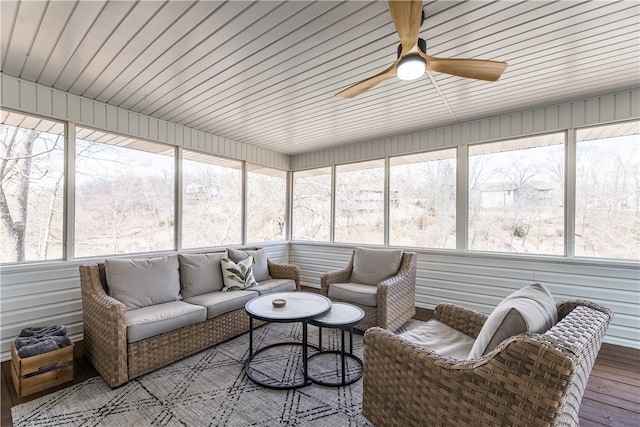 sunroom featuring wooden ceiling, ceiling fan, and a healthy amount of sunlight