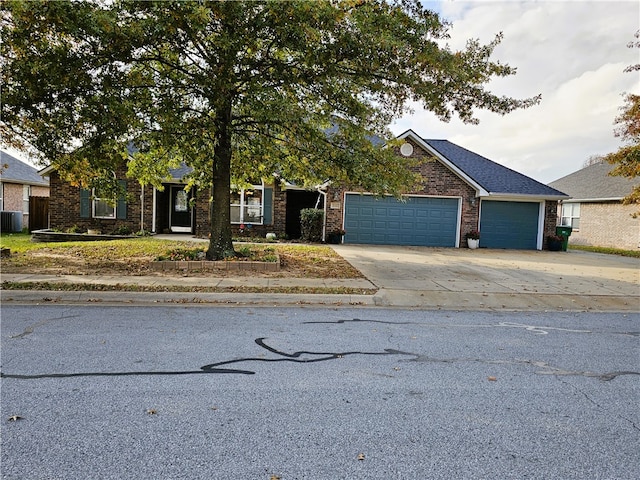 view of front facade with central AC unit and a garage