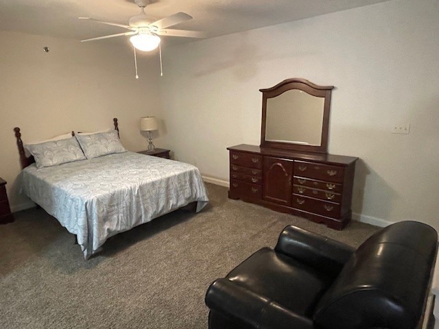 bedroom with ceiling fan and dark carpet