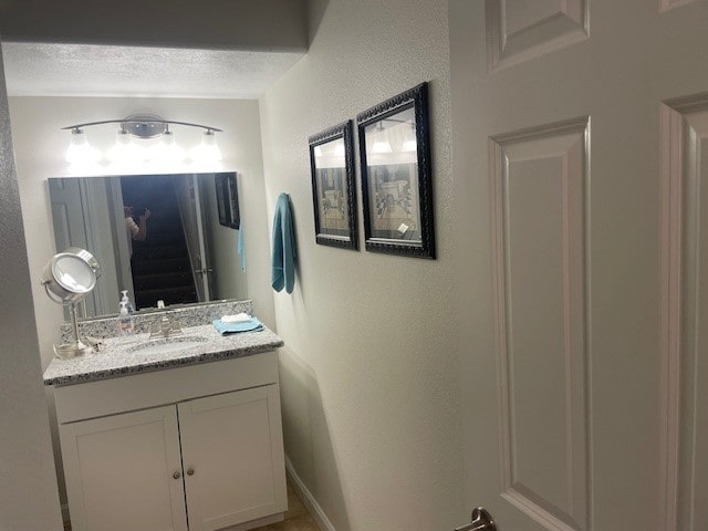 bathroom with vanity and a textured ceiling