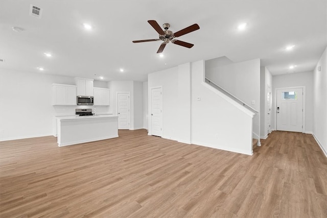 unfurnished living room featuring light hardwood / wood-style floors and ceiling fan