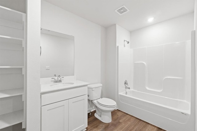 full bathroom featuring shower / tub combination, vanity, hardwood / wood-style flooring, and toilet