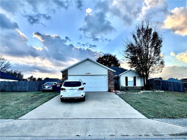 ranch-style home with a lawn and a garage