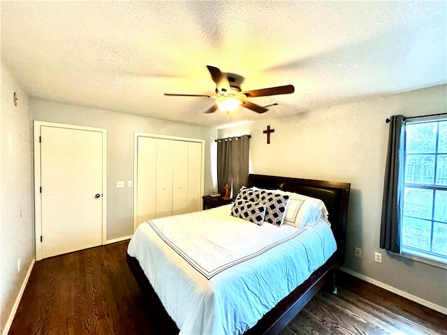 bedroom with ceiling fan, dark hardwood / wood-style floors, and a textured ceiling