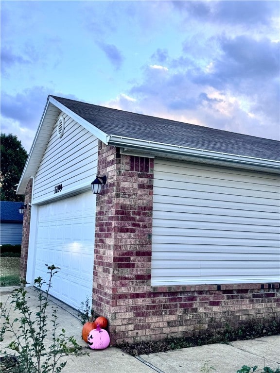 view of side of home featuring an outbuilding and a garage