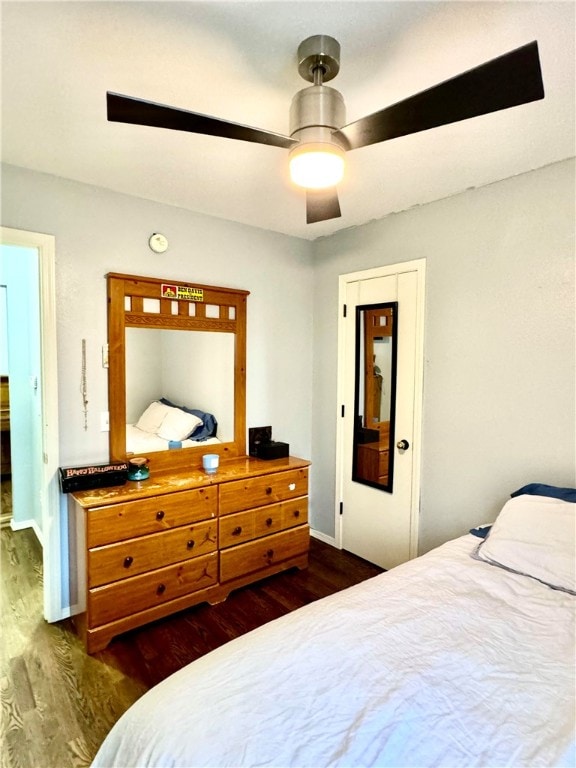 bedroom with ceiling fan and dark hardwood / wood-style flooring